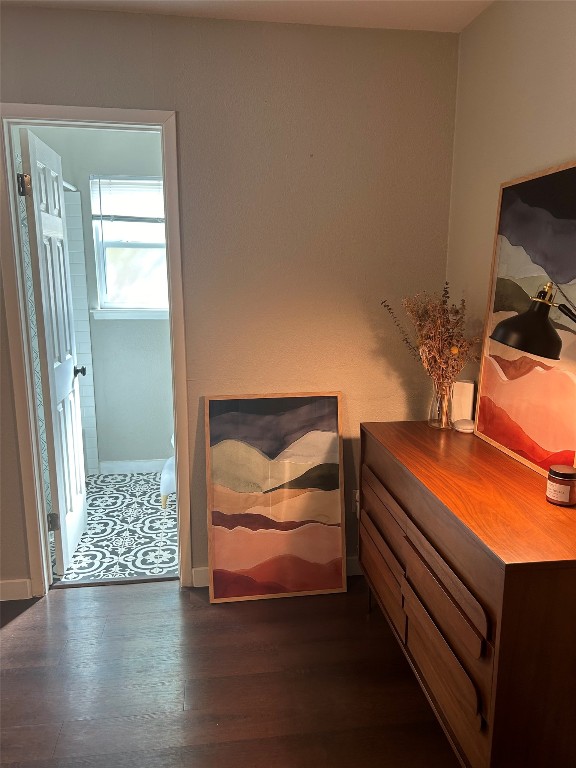 bedroom with dark wood-type flooring