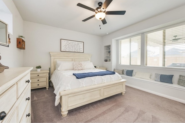 bedroom with ceiling fan and dark colored carpet