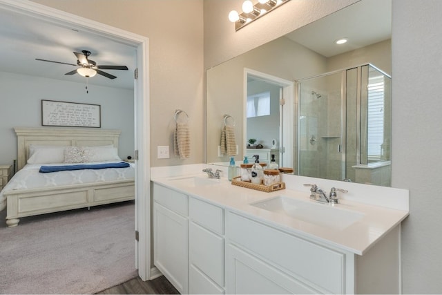 bathroom featuring vanity, a shower with door, and ceiling fan