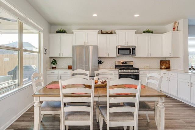 kitchen with tasteful backsplash, white cabinetry, a healthy amount of sunlight, and appliances with stainless steel finishes