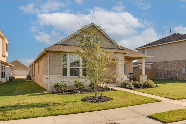 view of front of house with a front lawn and cooling unit