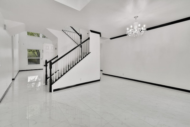 staircase with an inviting chandelier