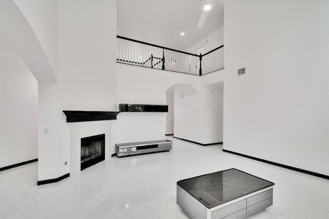 unfurnished living room with a towering ceiling