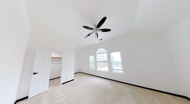 unfurnished room with vaulted ceiling, light carpet, and ceiling fan