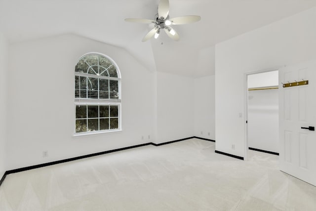 unfurnished room with lofted ceiling, light colored carpet, and ceiling fan