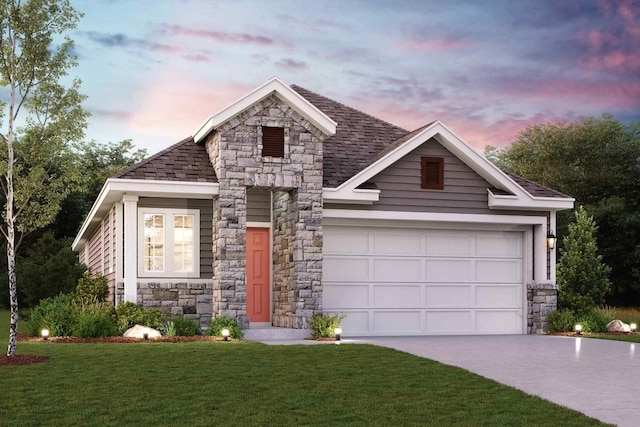 view of front of home featuring a garage and a yard