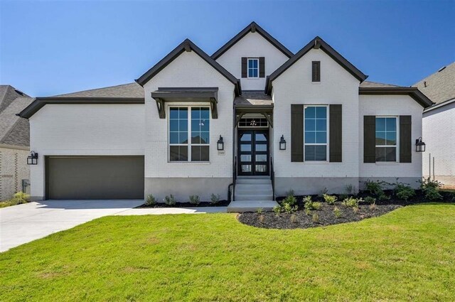 view of front of home with a front yard and a garage