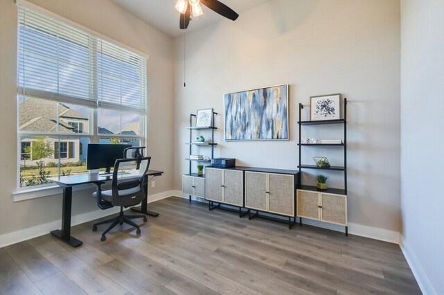 home office with ceiling fan, wood-type flooring, and a healthy amount of sunlight