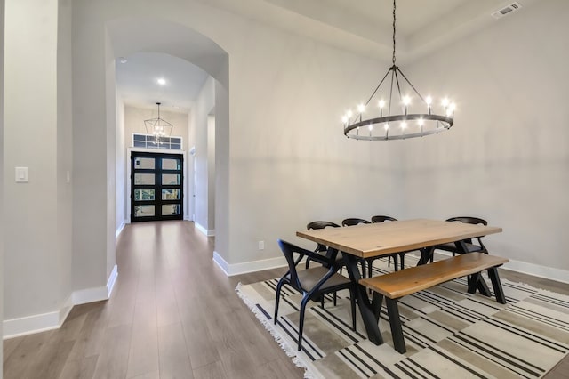 dining space with a chandelier and hardwood / wood-style floors