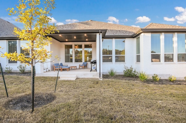 back of house featuring a yard and a patio area