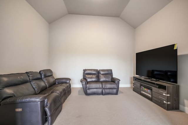 carpeted living room featuring lofted ceiling