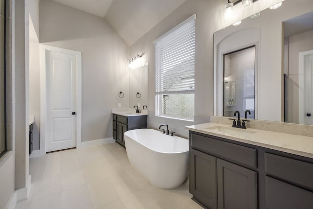 bathroom featuring vanity, independent shower and bath, tile patterned flooring, and vaulted ceiling