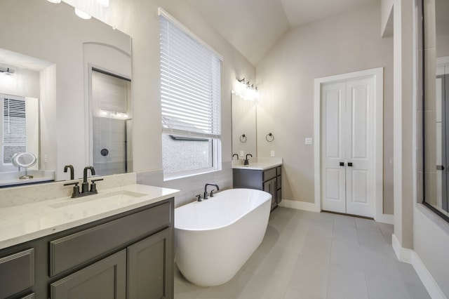 bathroom featuring vanity, independent shower and bath, tile patterned floors, and lofted ceiling