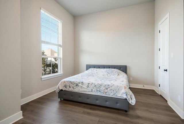 bedroom featuring dark hardwood / wood-style flooring