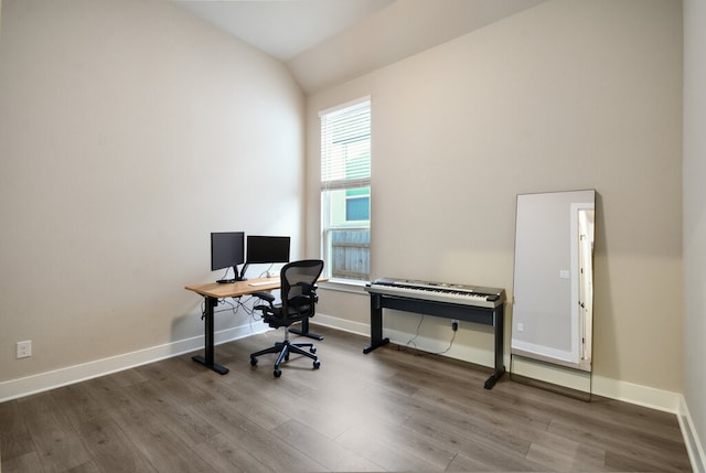 home office featuring lofted ceiling and hardwood / wood-style flooring