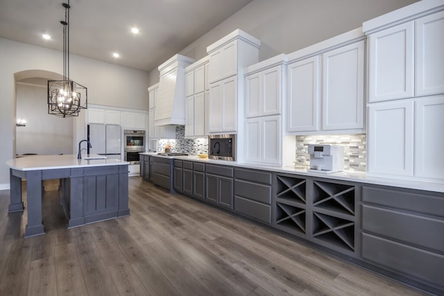 kitchen featuring dark hardwood / wood-style flooring, custom range hood, and white cabinets