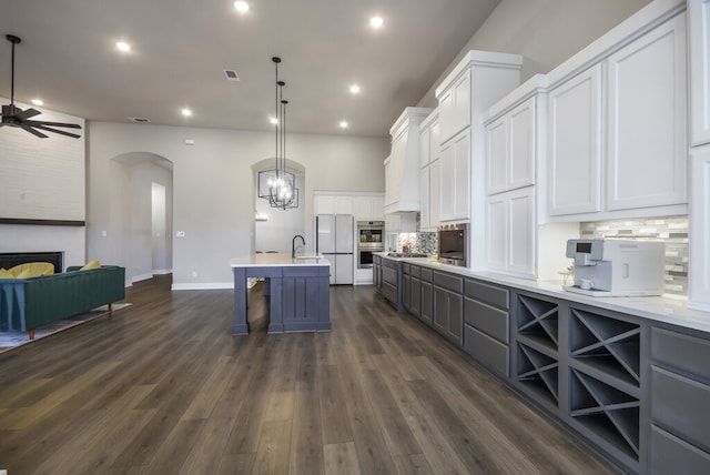 kitchen featuring white cabinetry, pendant lighting, backsplash, and dark hardwood / wood-style floors