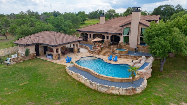 view of pool featuring a lawn, an in ground hot tub, a bar, and a patio area