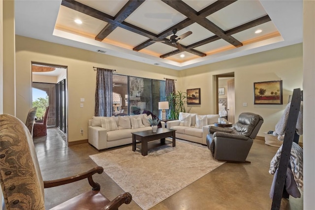 living room featuring finished concrete flooring, baseboards, and coffered ceiling