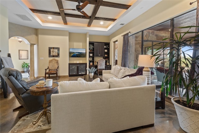 living room with ceiling fan, beam ceiling, ornate columns, and coffered ceiling