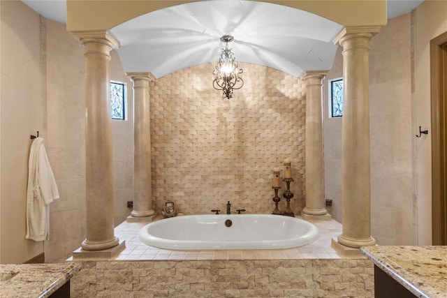 4609 Boxwood Bnd, Lago Vista, TX 78645 - full bathroom with decorative columns, a garden tub, plenty of natural light, and tile walls