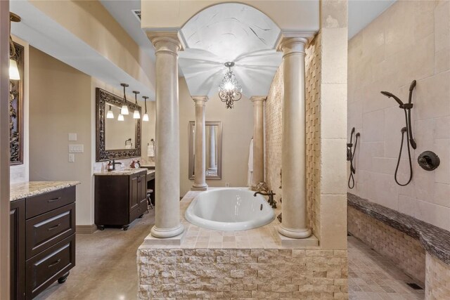 bathroom featuring vanity, plus walk in shower, and a notable chandelier