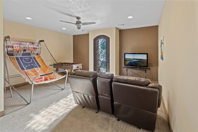 carpeted living room featuring ceiling fan