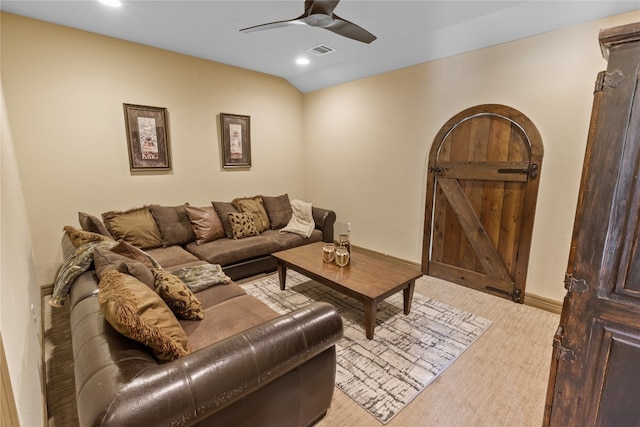 carpeted living room featuring a barn door and ceiling fan