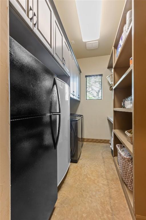 4609 Boxwood Bnd, Lago Vista, TX 78645 - washroom featuring washer and dryer, cabinet space, light floors, and baseboards