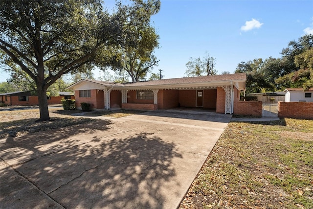 1311 Ridgehaven Dr, Austin, TX 78723 - ranch-style house featuring driveway, brick siding, fence, and an attached carport