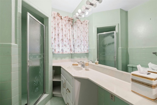 bathroom with tile patterned flooring, an enclosed shower, and vanity