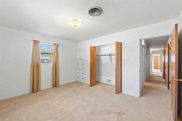 1311 Ridgehaven Dr, Austin, TX 78723 - unfurnished bedroom featuring light carpet, a closet, and baseboards