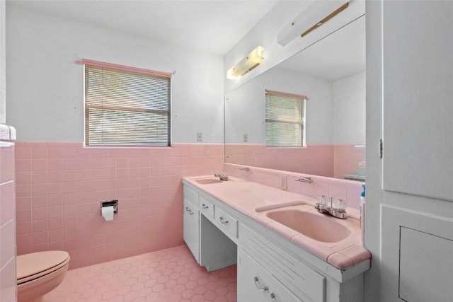1311 Ridgehaven Dr, Austin, TX 78723 - bathroom with tile walls, wainscoting, double vanity, toilet, and tile patterned floors