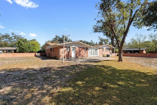 view of front of home with a front lawn and a patio area