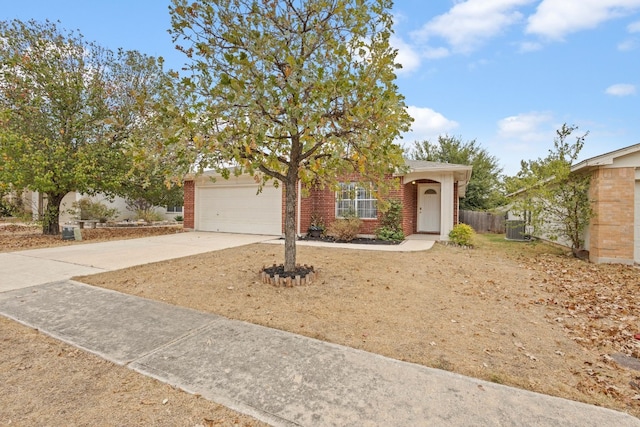 view of property hidden behind natural elements featuring a garage