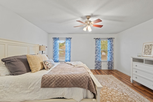 bedroom with ceiling fan and dark hardwood / wood-style floors