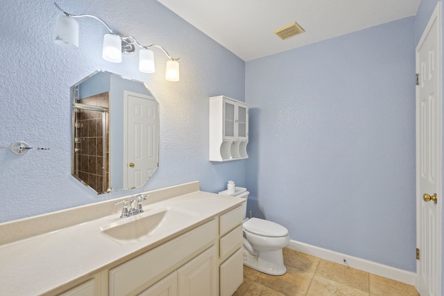 bathroom featuring walk in shower, tile patterned flooring, vanity, and toilet