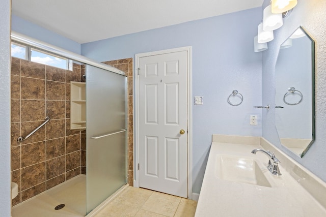 bathroom with vanity, an enclosed shower, and tile patterned flooring