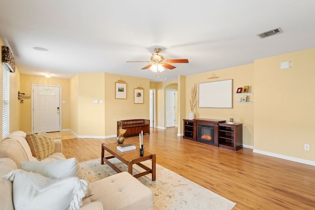 living room featuring ceiling fan and light hardwood / wood-style floors