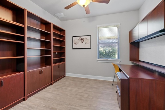 unfurnished office featuring light wood-type flooring and ceiling fan