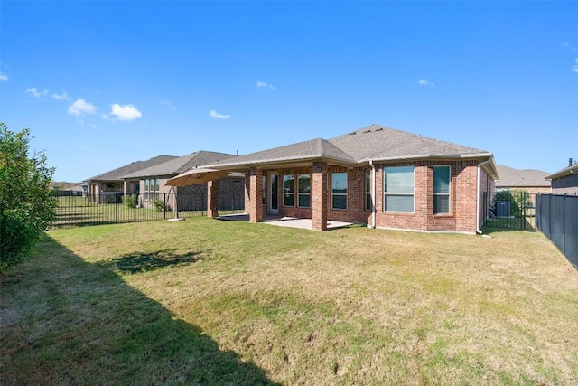 rear view of house featuring a patio area and a yard