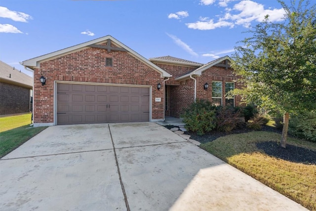 view of front of property featuring a garage and a front lawn