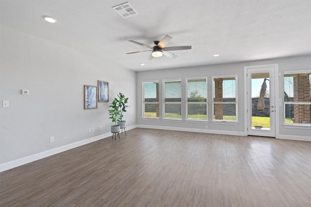 unfurnished room with ceiling fan, wood-type flooring, and a textured ceiling