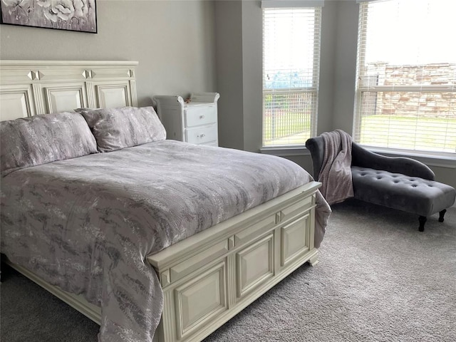 bedroom with multiple windows and light colored carpet