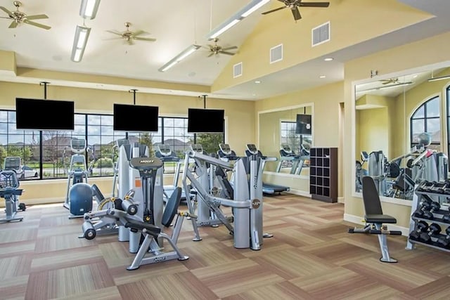 workout area with light carpet, a high ceiling, and ceiling fan