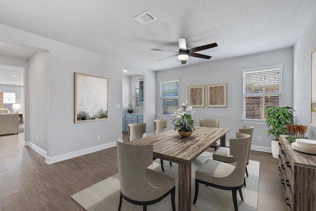 dining space with dark hardwood / wood-style floors and ceiling fan