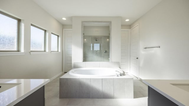 bathroom with tile patterned flooring, vanity, and shower with separate bathtub