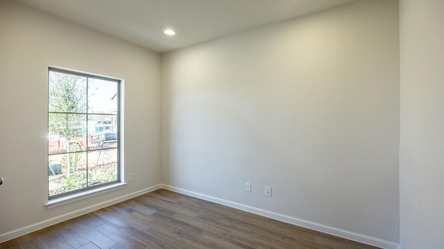 spare room with hardwood / wood-style flooring