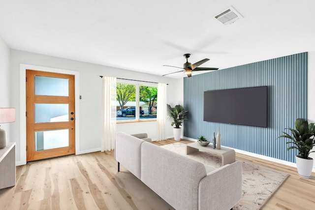 living room with ceiling fan and light hardwood / wood-style floors