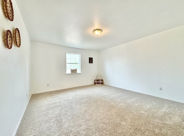 carpeted spare room featuring a textured ceiling